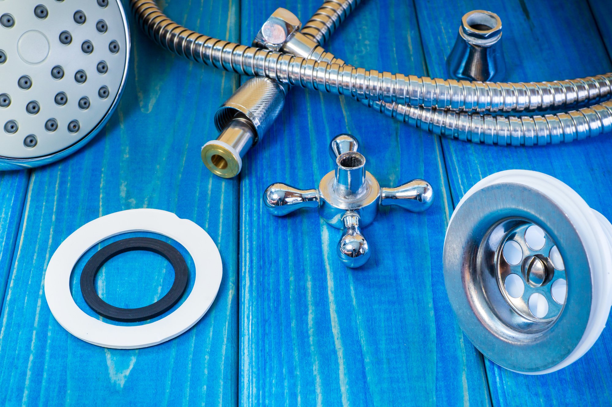 Accessories for plumbing repairs or washing in the kitchen on a wooden background.